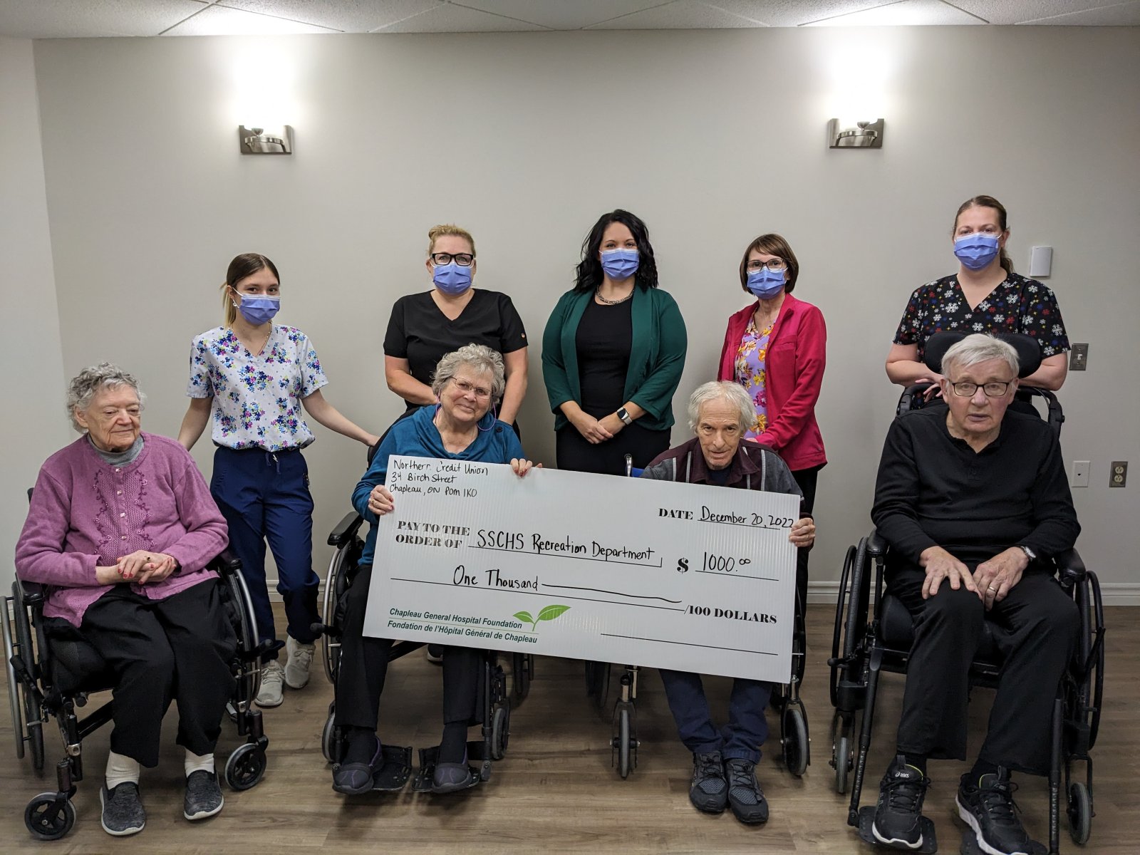 Northern Credit Union members holding giant donation cheque